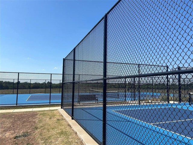 view of tennis court with fence