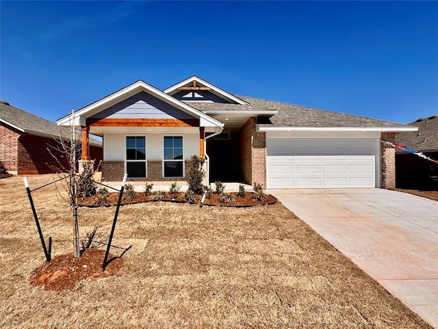 view of front facade featuring brick siding, an attached garage, and concrete driveway