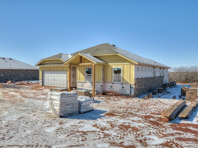 property under construction with a garage, roof with shingles, and board and batten siding