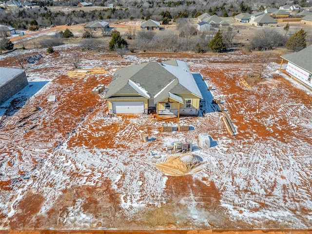 snowy aerial view featuring a residential view