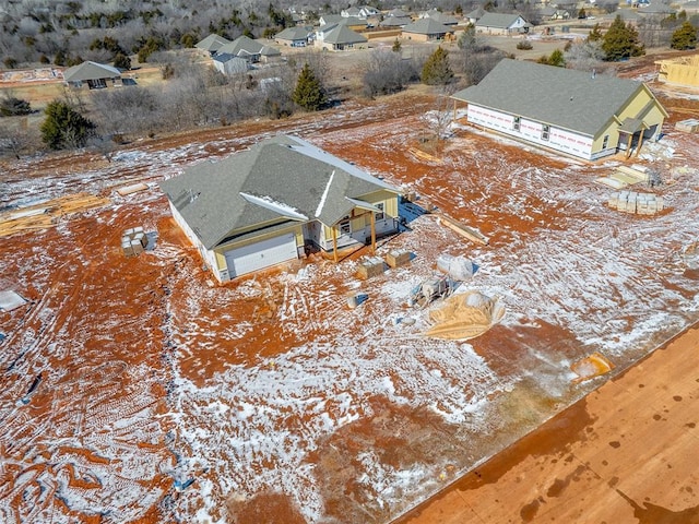 snowy aerial view featuring a residential view