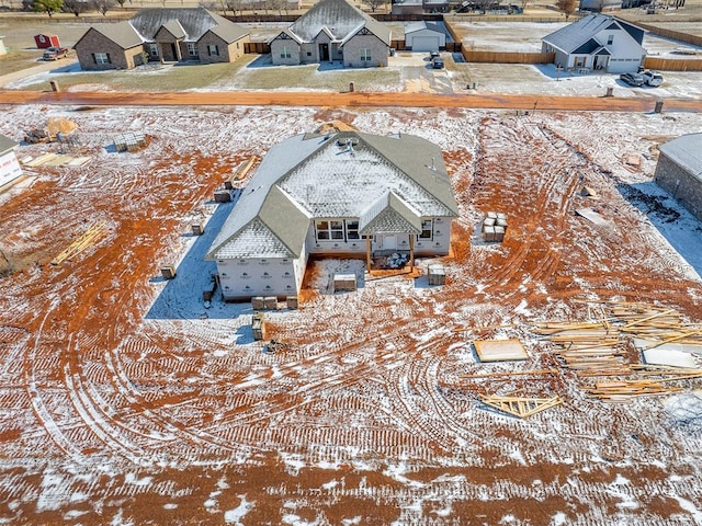 snowy aerial view with a residential view