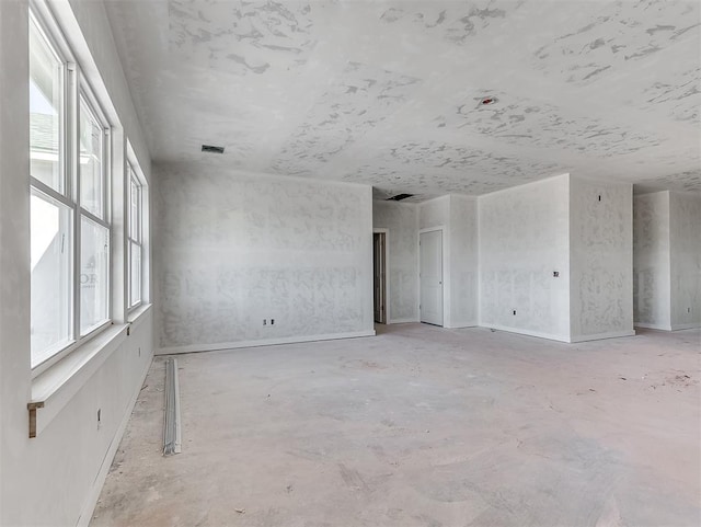 empty room featuring visible vents and a wealth of natural light