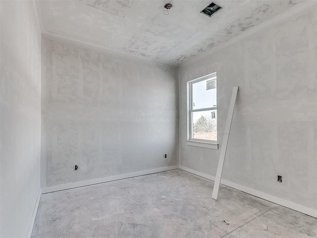 unfurnished room featuring baseboards