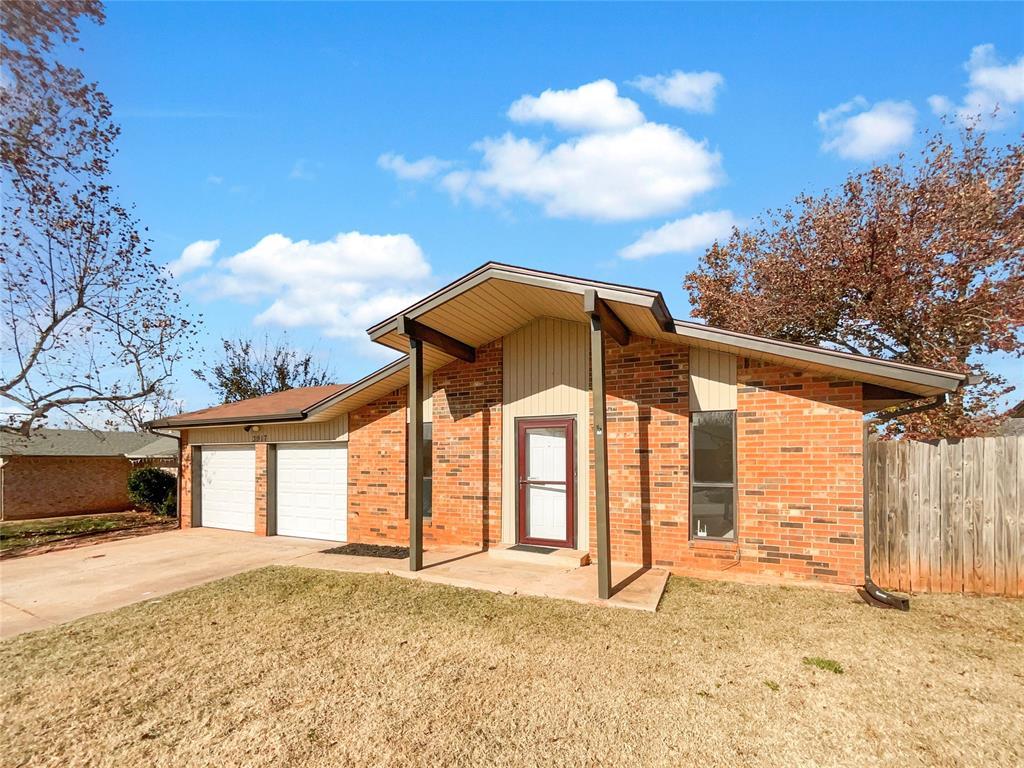 exterior space featuring a garage and a lawn