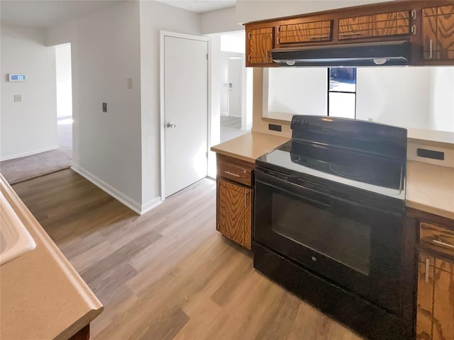 kitchen with light hardwood / wood-style floors and black electric range oven