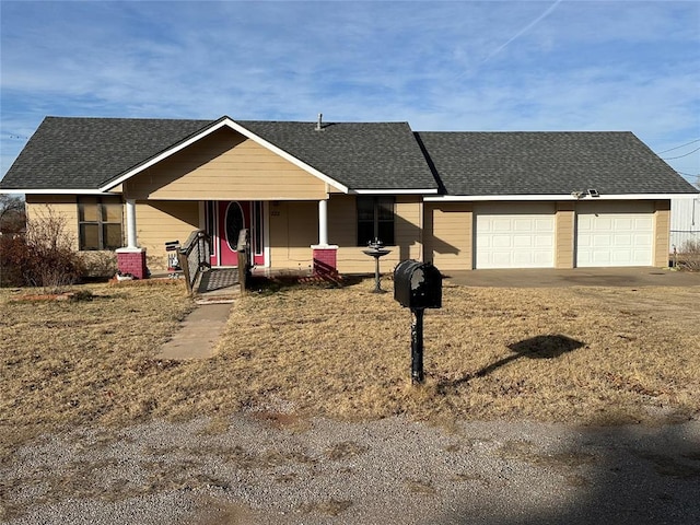 ranch-style house with covered porch and a garage