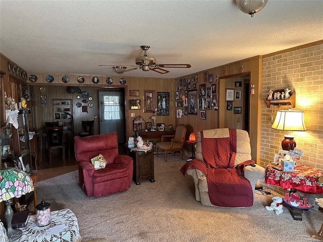 living room featuring carpet, wood walls, and a textured ceiling