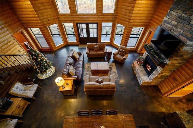 living room with a fireplace and a towering ceiling