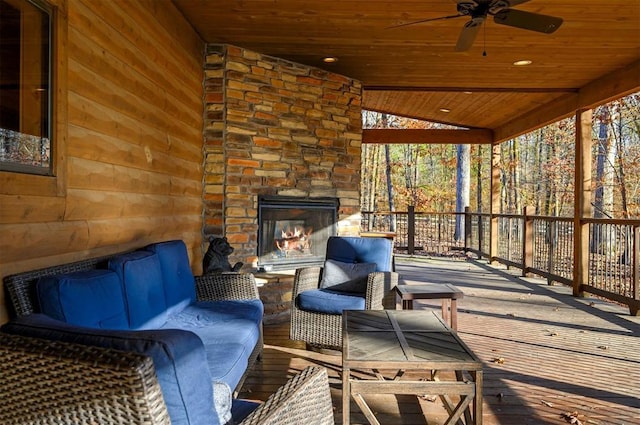 exterior space with an outdoor stone fireplace and ceiling fan