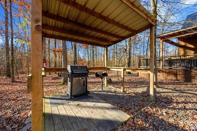 wooden deck featuring area for grilling