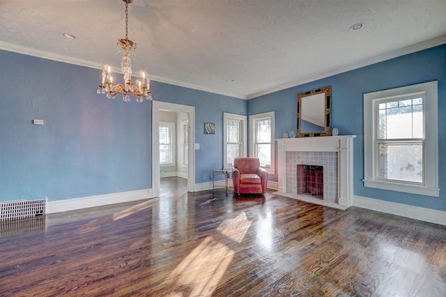 living room with dark hardwood / wood-style floors, a healthy amount of sunlight, and ornamental molding