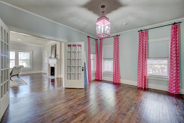 unfurnished room featuring ornamental molding, a textured ceiling, and dark wood-type flooring