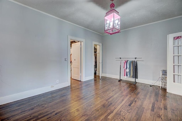 empty room with dark hardwood / wood-style flooring and ornamental molding