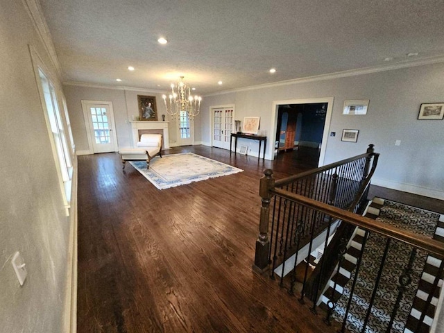 living room with dark hardwood / wood-style flooring, ornamental molding, and a textured ceiling