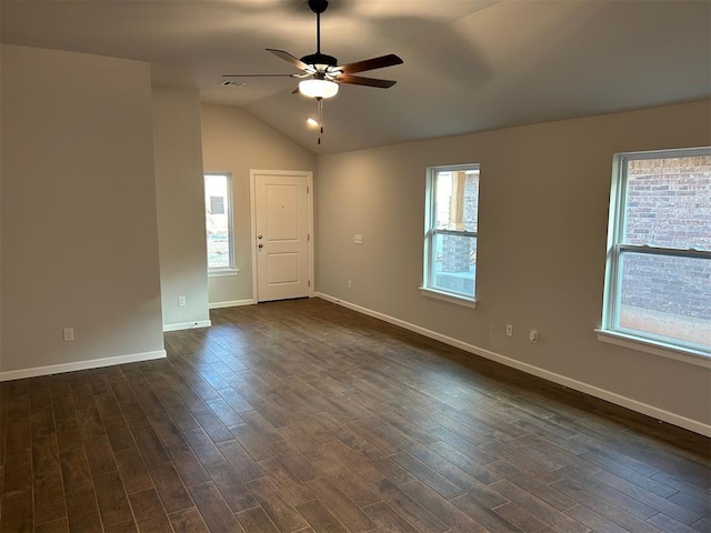 spare room with a wealth of natural light, lofted ceiling, ceiling fan, and dark wood-type flooring