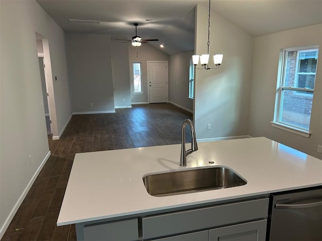 kitchen featuring dishwasher, sink, vaulted ceiling, an island with sink, and decorative light fixtures