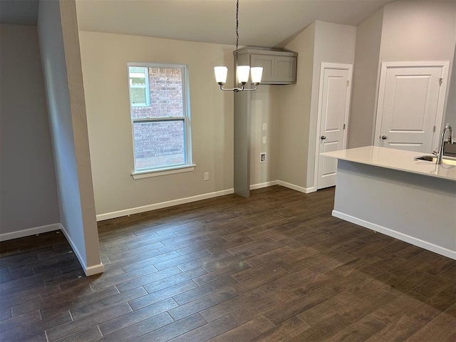 unfurnished dining area with sink and a notable chandelier