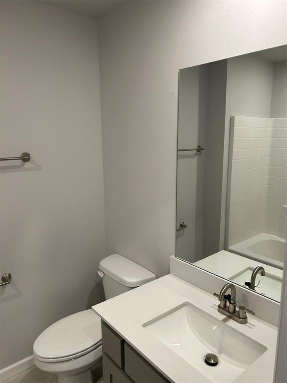 bathroom featuring tile patterned flooring, vanity, and toilet