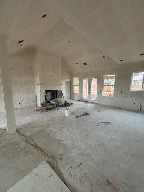 unfurnished living room featuring vaulted ceiling