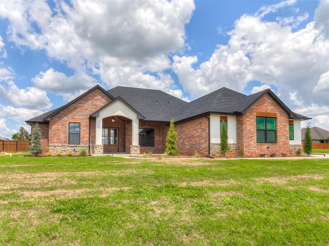 2233 W Sunset Dr, Mustang, OK 73064 - view of front facade with roof with shingles and brick siding