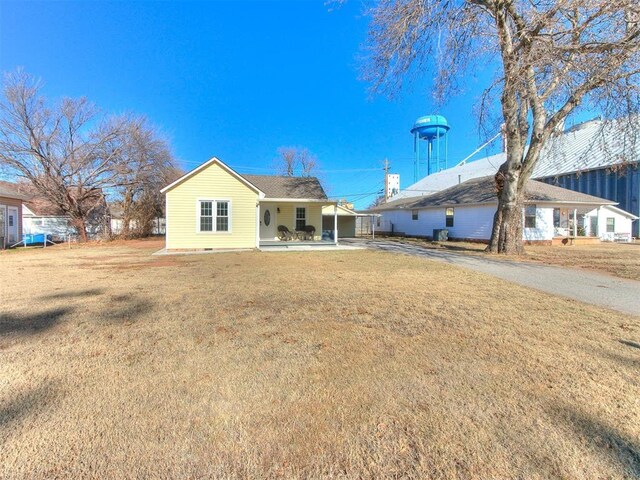 back of property with a lawn