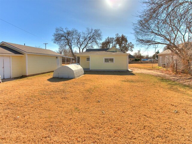 rear view of house with a yard