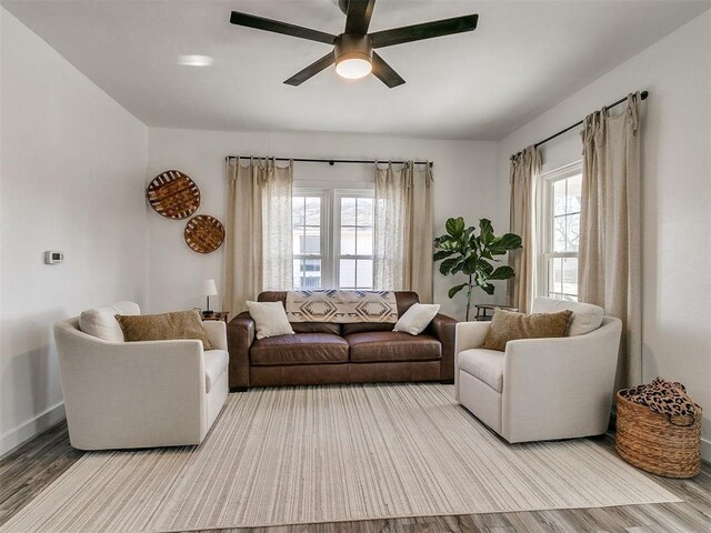 living room featuring light hardwood / wood-style flooring and ceiling fan