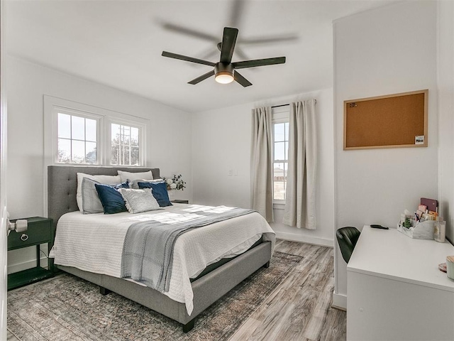 bedroom with hardwood / wood-style flooring and ceiling fan