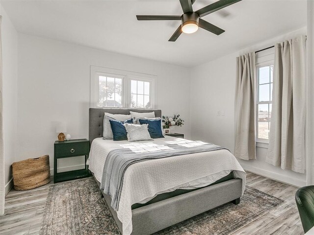 bedroom featuring light hardwood / wood-style floors and ceiling fan