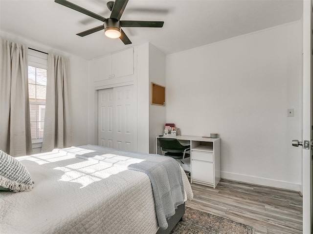 bedroom with hardwood / wood-style floors, a closet, and ceiling fan