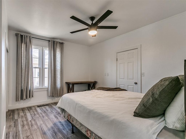 bedroom featuring ceiling fan and hardwood / wood-style floors