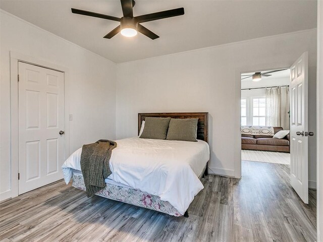 bedroom with hardwood / wood-style floors and ceiling fan