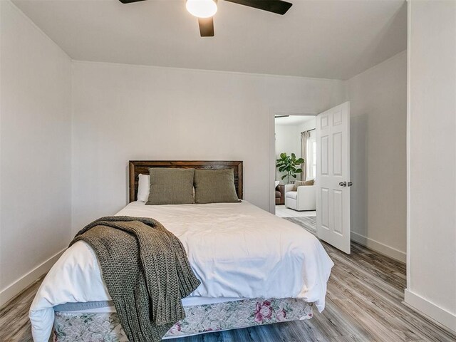 bedroom with ceiling fan and hardwood / wood-style flooring