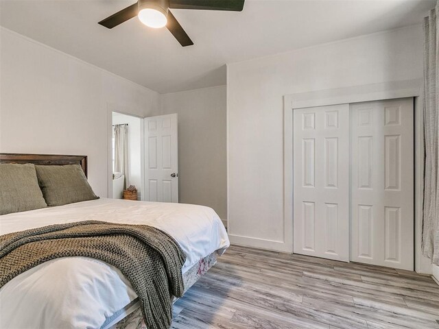 bedroom featuring ceiling fan, light hardwood / wood-style floors, and a closet