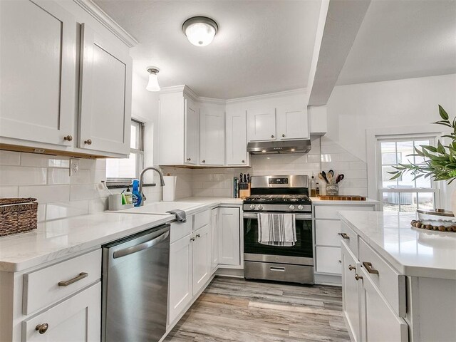 kitchen with white cabinetry, sink, and appliances with stainless steel finishes