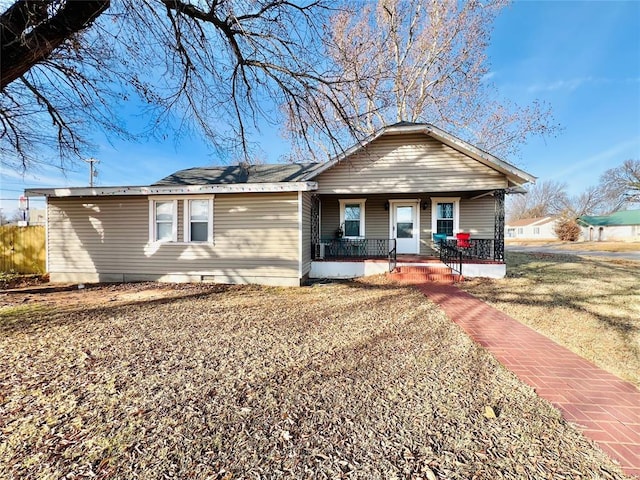 single story home with covered porch and a front yard