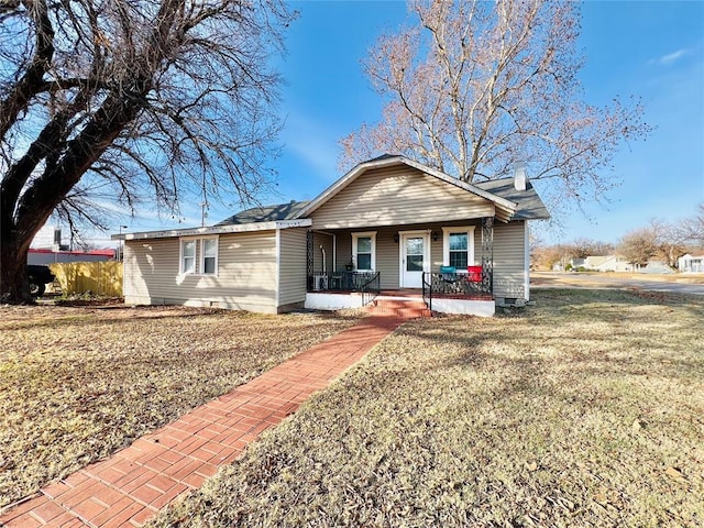 ranch-style house featuring a front yard and a porch