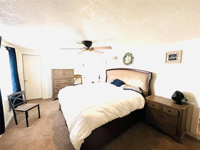 carpeted bedroom with a textured ceiling and ceiling fan