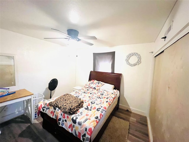 bedroom with ceiling fan, a closet, and dark hardwood / wood-style floors