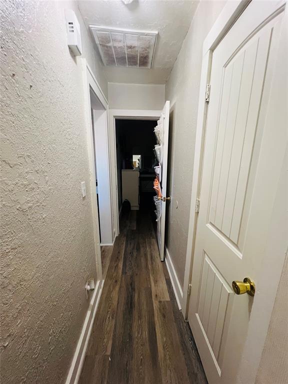 corridor featuring dark hardwood / wood-style flooring