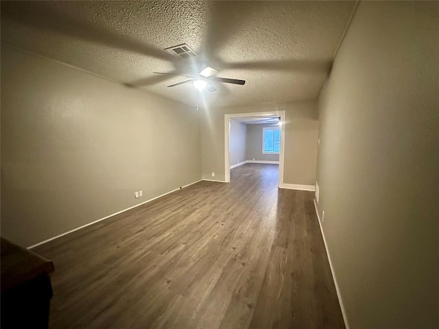 additional living space with ceiling fan, a textured ceiling, and hardwood / wood-style flooring