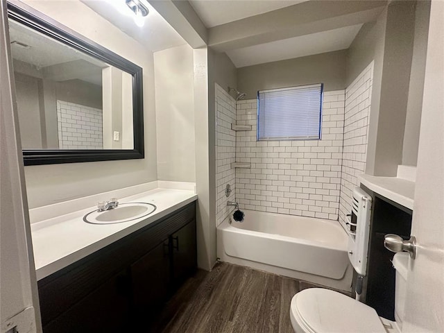 full bathroom with vanity, toilet, wood-type flooring, and tiled shower / bath combo