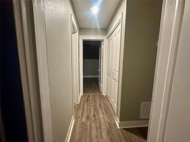 corridor featuring wood-type flooring