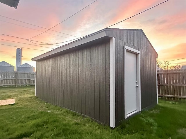 outdoor structure at dusk featuring a yard