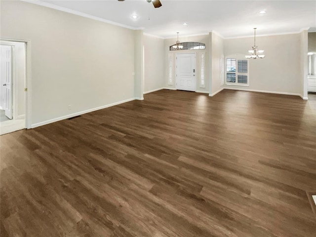 unfurnished living room featuring ceiling fan with notable chandelier, crown molding, and dark wood-type flooring