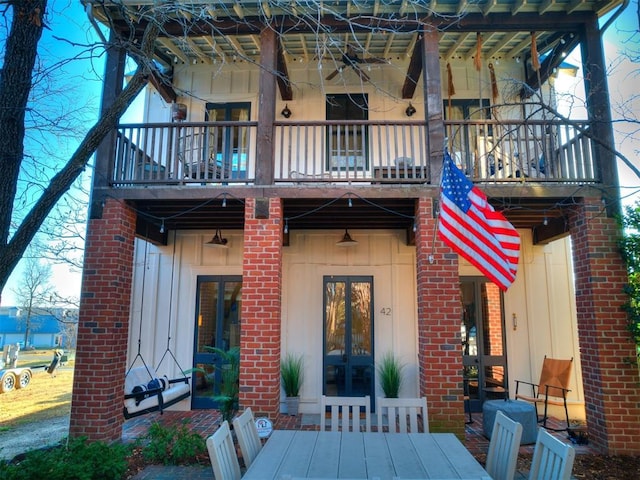 rear view of house with french doors and a balcony