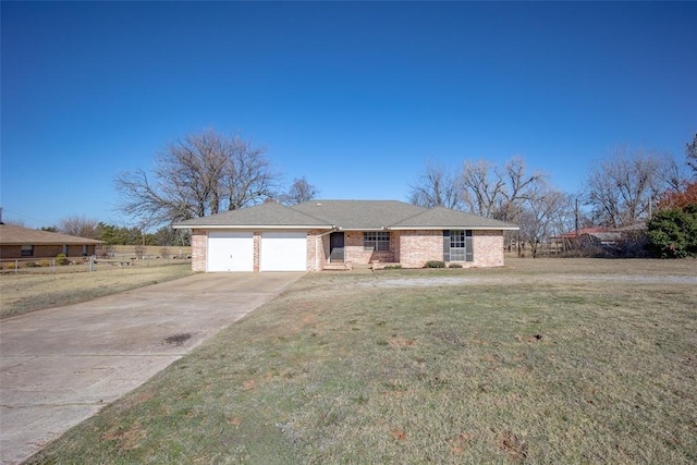 ranch-style house featuring a garage and a front lawn