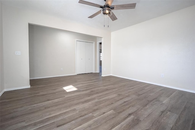 spare room with ceiling fan and dark hardwood / wood-style floors