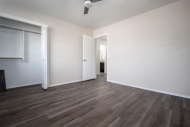 unfurnished bedroom with a closet, ceiling fan, and dark hardwood / wood-style flooring